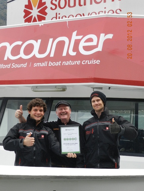 Southern Discoveries Milford Staff celebrating their Certificate of Excellence from Tripadvisor - Pedro Benardi (boat host), Max Darrock (skipper) and Dave Newman (Nature Guide).