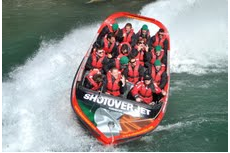 Players Brian O'Driscoll and Ronan O'Gara are among Irish rugby team members enjoying a ride on a Shotover Jet boat sporting the Irish flag