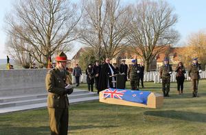 Alongside his countrymen at last. Lieutenant Colonel Nick Gillard opens the reburial service for the unknown soldier of the New Zealand Rifle Brigade at the Messines Ridge British Cemetery last week.