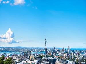 A stunning view of Auckland's iconic skyline under clear blue skies, showcasing the beauty and vibrancy of the city.