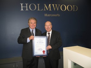 Robert Bevan, left, presenting Best Practice Accreditation certificate to Harcourts Holmwood General Manager Tony Jenkins