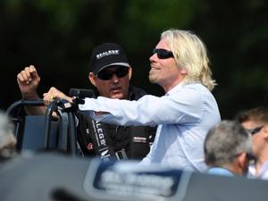 Sir Richard Branson at the wheel of a Sealegs amphibious marine craft on Auckland's Waitemata Harbour