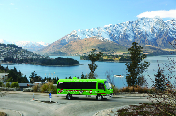 The Kiwi Circle Bus with The Remarkables and Lake Wakatipu in the background.