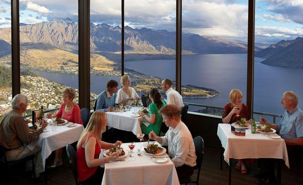 Guests dining at Skyline Queenstown Restaurant and enjoying one of the world's best views.