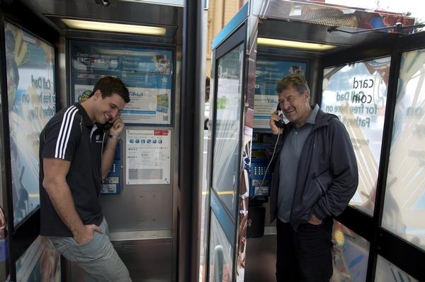 (Left) Anthony Boric with his Dad Milenko Boric at a pay phone in Downtown, Auckland. Telecom are opening up pay phones for free calling to landlines during Father's Day tomorrow, Sunday 2 September.