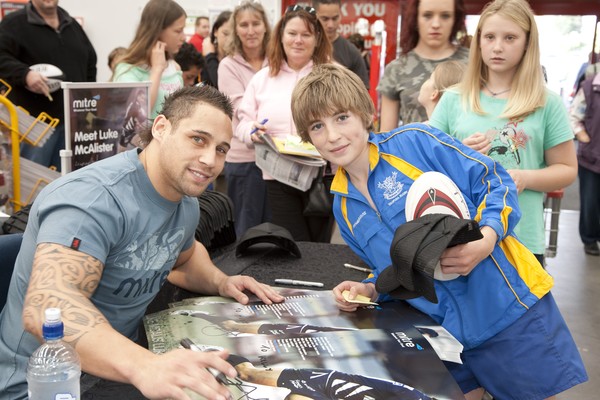 international rugby star Luke McAlister, With  Kelly Douglas, 13, at The Warehouse, Albany where he met with fans to say hi and autograph Mitre caps and shoes.