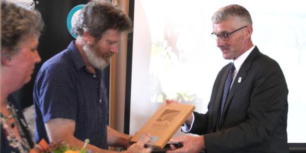 Wools of New Zealand chairman Mark Shadbolt presents Ruth and Ross Richards with the Grower of the Year award recently in Napier