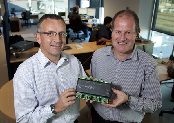 Stephen Donovan (Business Development Director) left and Mark Radburnd (partner) holding on to a Turningpoint 16-channel on-line system that is installed inside the wind turbine.