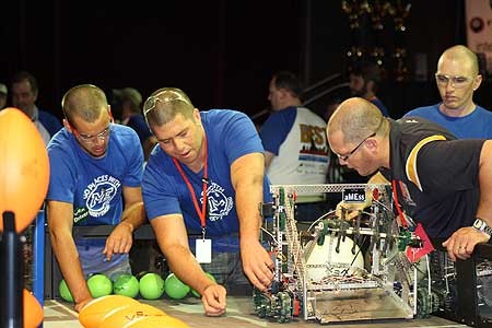 Massey University's Albany team Martin Pike, Maurice Tipene, lecturer Dr Johan Potgieter and Jonathan Aston check their robot.