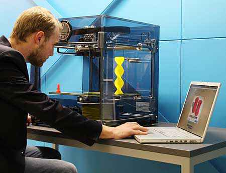 Massey industrial design student Nick van Halderen in the Fab Lab with a 3D printer from MIT.