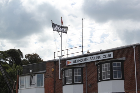 The NZL Sailing Team flag flies at Weymouth Sailing Club