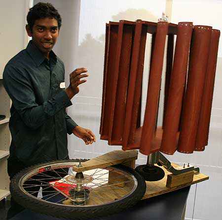 Pamitha Wijesundera with an electricity  generating system using a bicycle wheel.