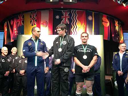 Hayden Pritchard (centre) receives his gold medal at the Oceania Powerlifting championships at the weekend.