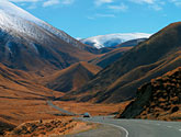 The Lindis Pass is memorable for its triangular hills clad in tussock grass.