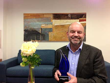 Massey University mediation teacher Geoff Sharp with his Mediator of the Year award.