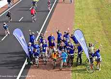 Cyclists gather under the Clark Lane footbridge.