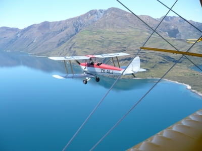 Tiger Moth flies over Lake Wanaka.